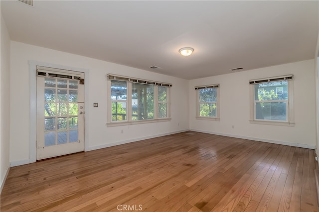 empty room with light hardwood / wood-style floors