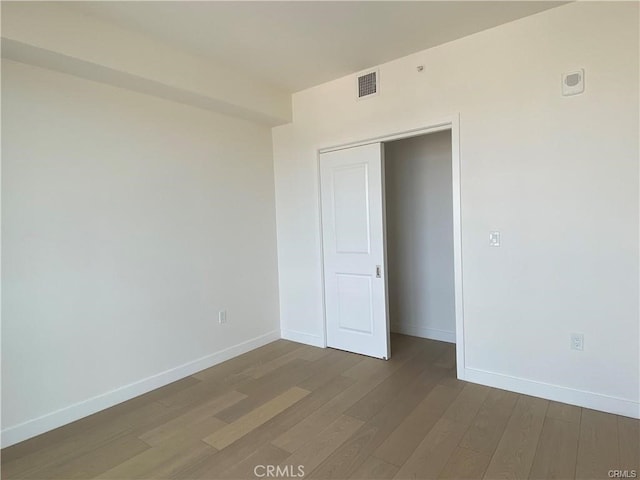 unfurnished bedroom with hardwood / wood-style floors