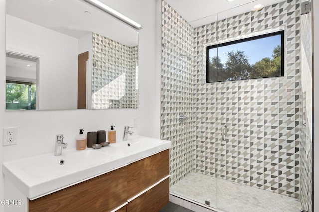 bathroom featuring vanity, a healthy amount of sunlight, and an enclosed shower