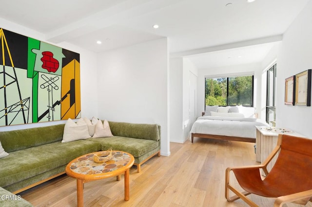 interior space with beam ceiling and light wood-type flooring