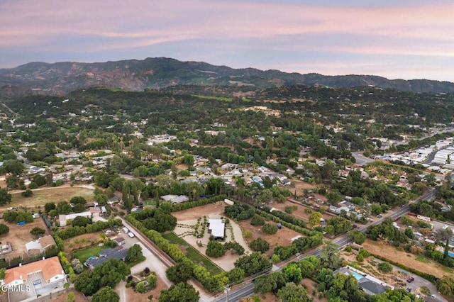 aerial view at dusk featuring a mountain view