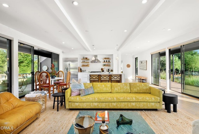 living room with beamed ceiling and light hardwood / wood-style floors