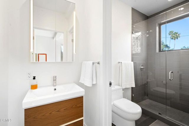 bathroom featuring walk in shower, vanity, and toilet