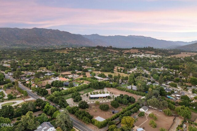 aerial view at dusk featuring a mountain view