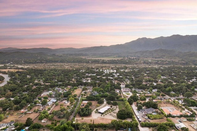 aerial view at dusk featuring a mountain view