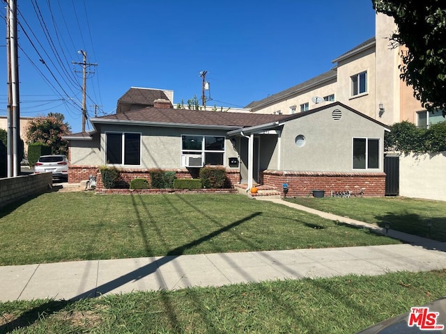 view of front of house with cooling unit and a front yard