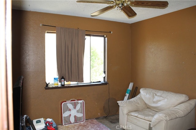 sitting room featuring ceiling fan