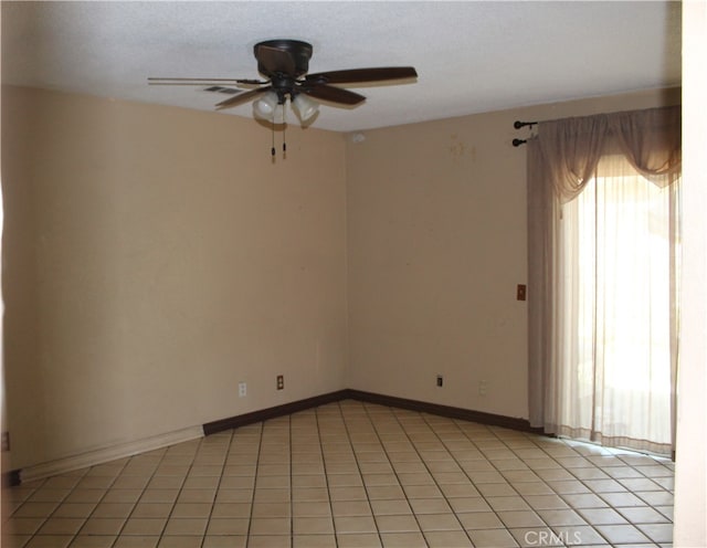 tiled empty room with ceiling fan