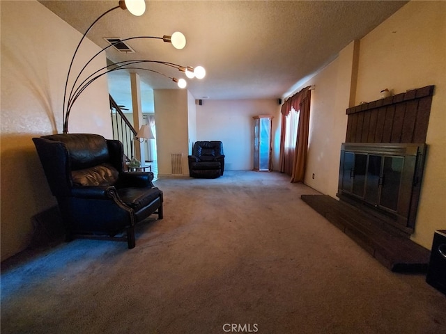 living area with a textured ceiling and carpet flooring