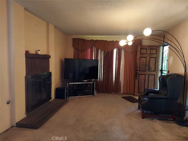 carpeted living room featuring a textured ceiling