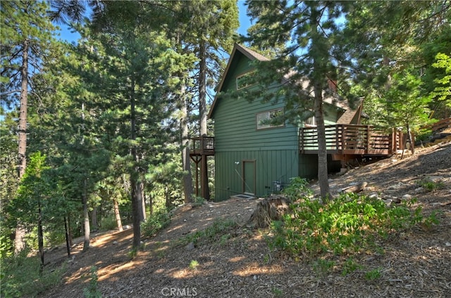 view of home's exterior featuring a wooden deck