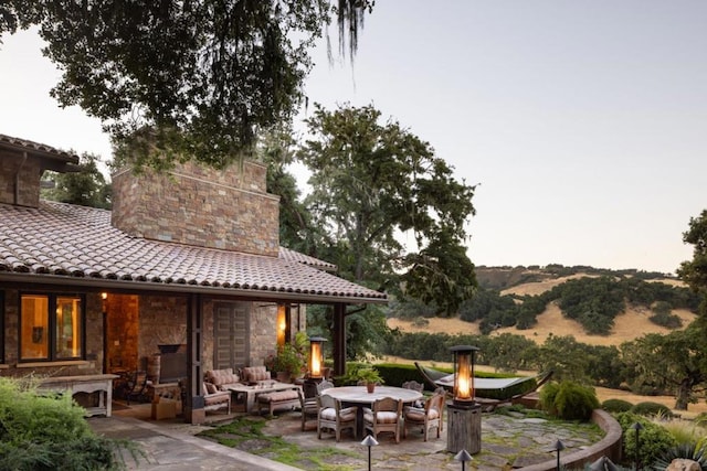 view of patio with an outdoor living space and a mountain view