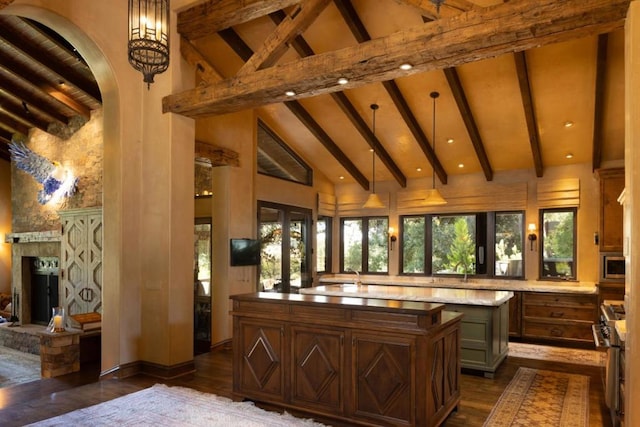 bar with beam ceiling, stainless steel appliances, high vaulted ceiling, and hanging light fixtures