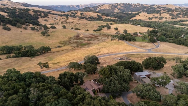 drone / aerial view featuring a mountain view and a rural view