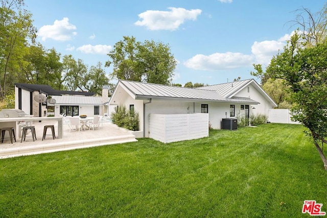 back of house with a patio area, a yard, and cooling unit