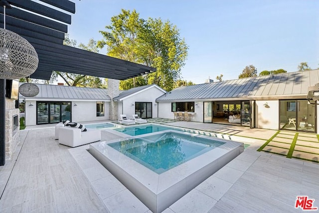 view of swimming pool with an in ground hot tub and a patio area