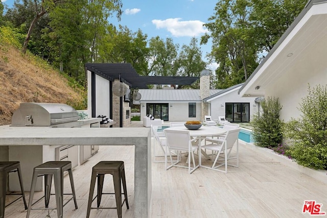 view of patio with an outdoor kitchen and a bar