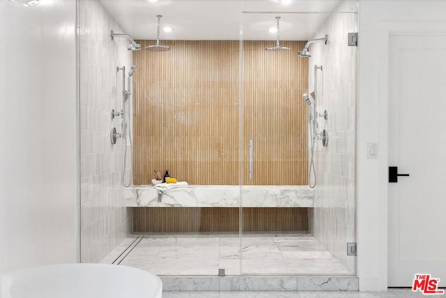 bathroom with a shower with door