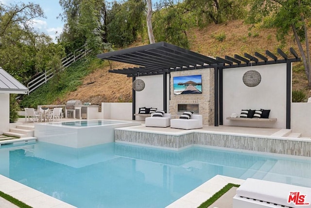 view of swimming pool with area for grilling and an outdoor stone fireplace