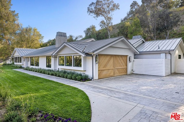 single story home featuring a front yard and a garage