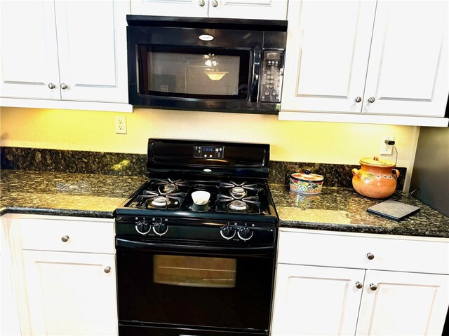 kitchen featuring dark stone counters, white cabinets, and black appliances