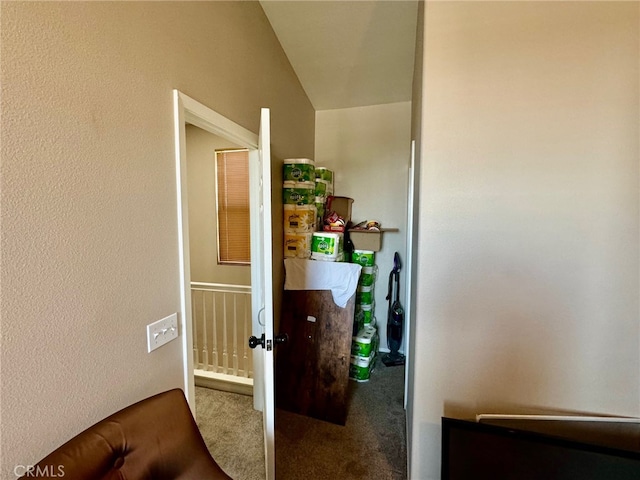 corridor with carpet and vaulted ceiling