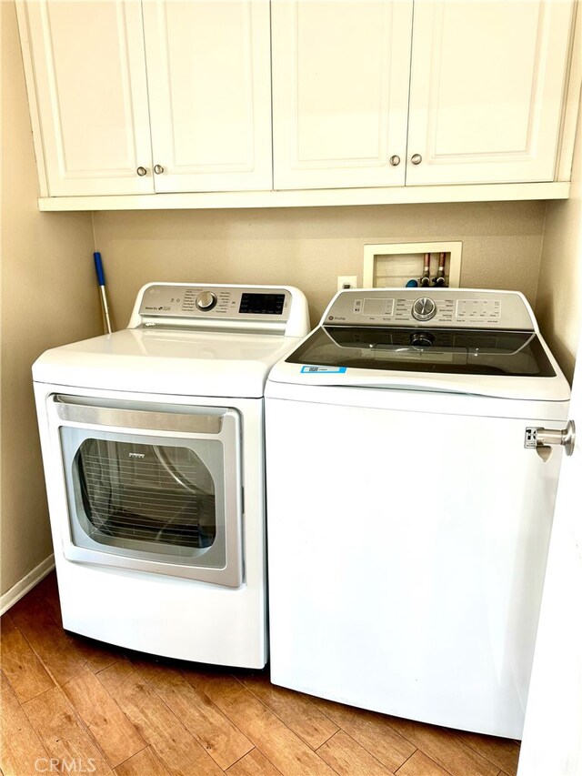 laundry room featuring light hardwood / wood-style floors and independent washer and dryer