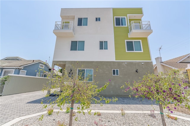 back of house featuring a balcony