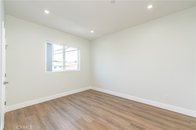 unfurnished room with light wood-type flooring