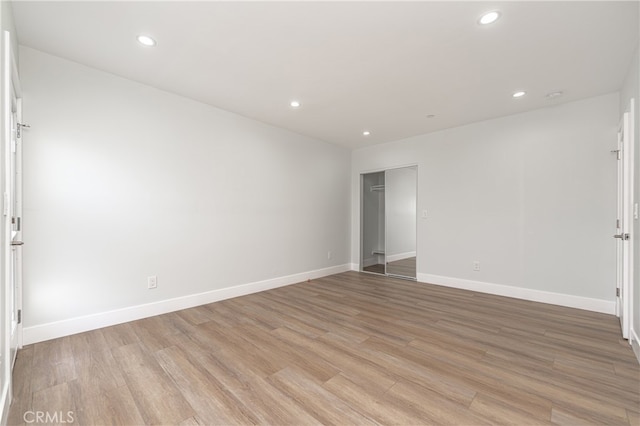 spare room with light hardwood / wood-style floors