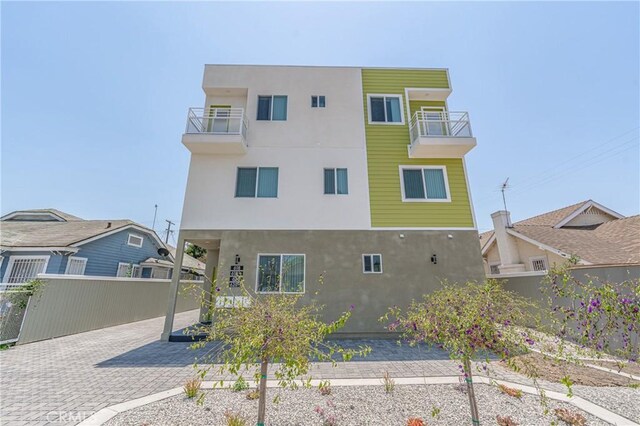 rear view of property featuring a balcony