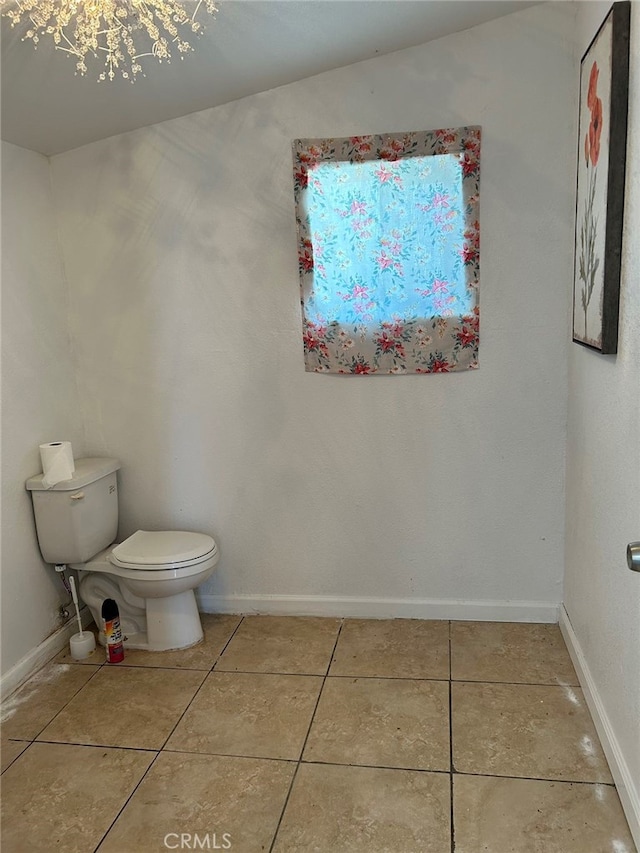 bathroom with tile patterned floors, vaulted ceiling, and toilet