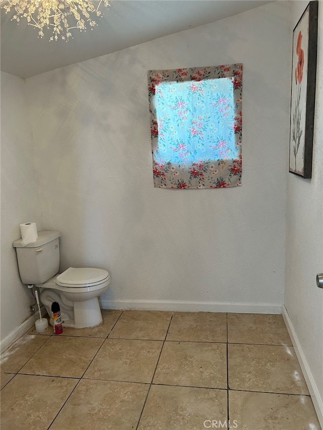 bathroom featuring lofted ceiling, toilet, and tile patterned flooring