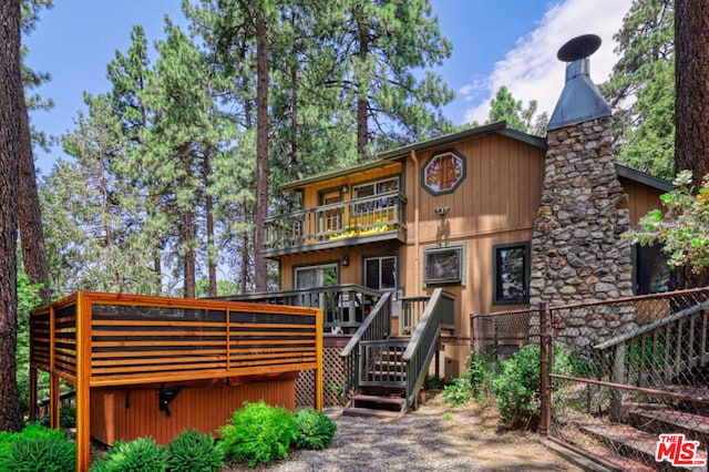 rear view of property featuring a balcony