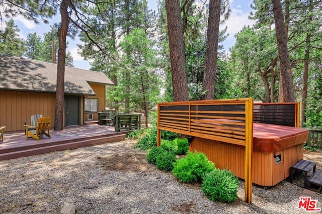 view of yard with a hot tub and a deck