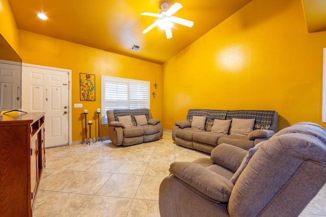 tiled living room with ceiling fan and high vaulted ceiling