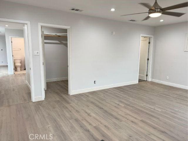 6053 Turnergrove Dr, Lakewood, CA 90713 - unfurnished bedroom with a spacious closet, baseboards, wood finished floors, recessed lighting, and a closet