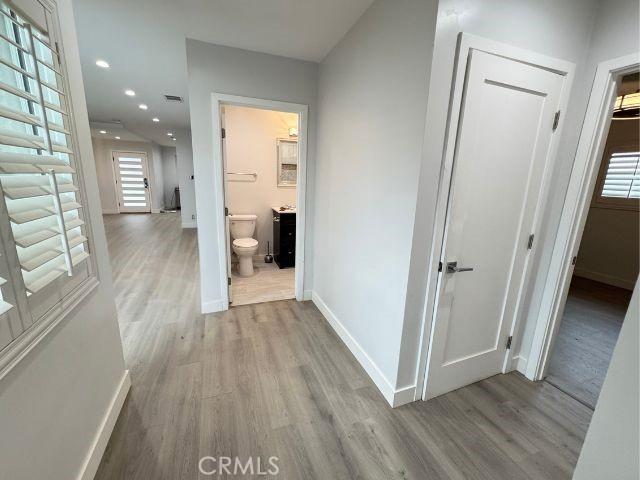 6053 Turnergrove Dr, Lakewood, CA 90713 - hallway with wood finished floors, baseboards, and recessed lighting