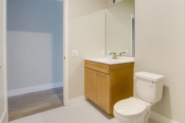 bathroom featuring hardwood / wood-style floors, vanity, and toilet