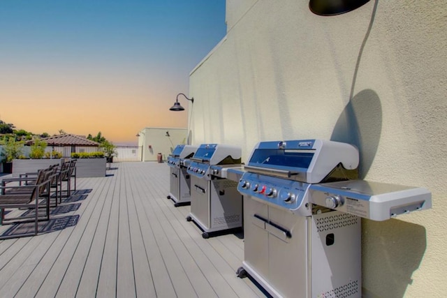 deck at dusk with a grill