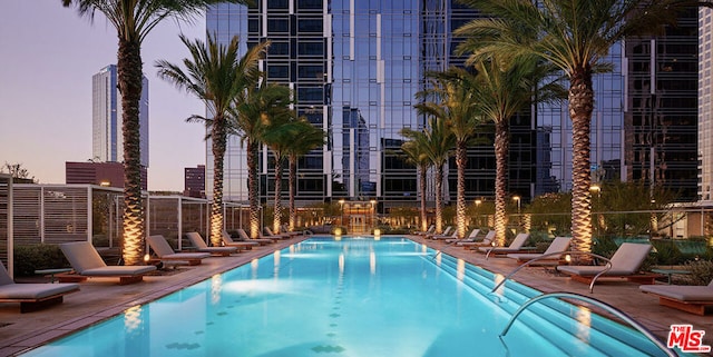 view of pool at dusk