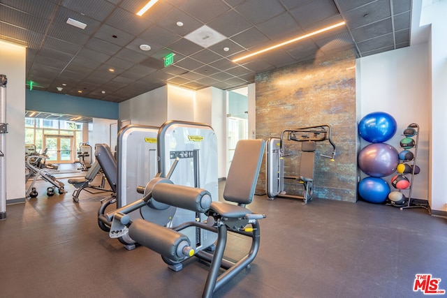 exercise room featuring a paneled ceiling