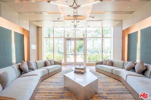 living room featuring a wall of windows and french doors