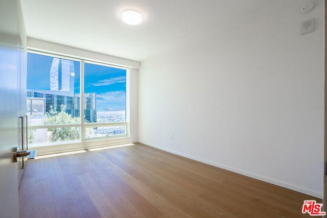 unfurnished room featuring hardwood / wood-style flooring