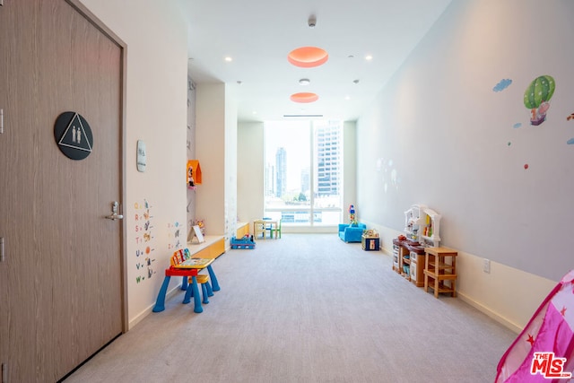 game room with light carpet and expansive windows