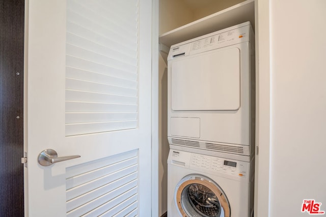 washroom featuring stacked washing maching and dryer