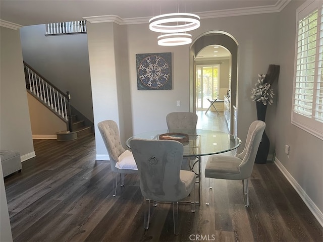 dining room featuring ornamental molding, plenty of natural light, and dark hardwood / wood-style floors