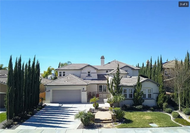 view of front facade with a front yard and a garage