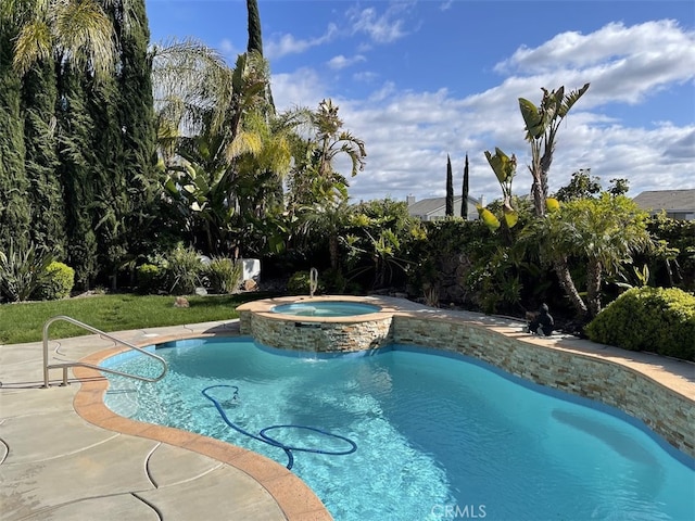 view of pool with an in ground hot tub