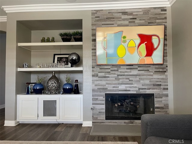 bar with crown molding, built in features, a tile fireplace, and dark hardwood / wood-style flooring